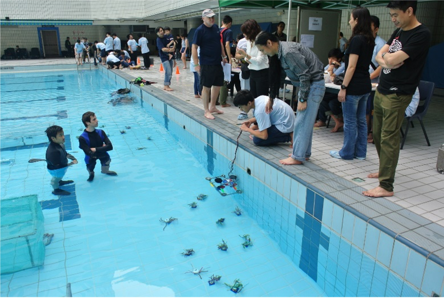 Students from Ebenezer School & Home for the Visually Impaired controlling robots at the poolside during the underwater robot competition in 2013, where they ultimately achieved an impressive second place. 