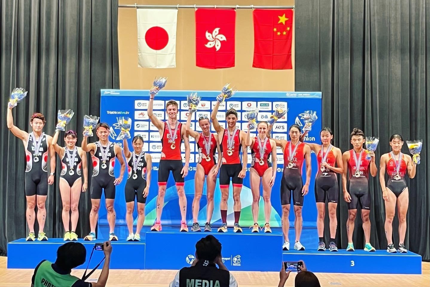 After winning team gold at the Asian Triathlon U23 and Junior Championships in Japan, Jason (sixth from the right) and his teammates stand atop the podium to celebrate their accomplishment. (Photo: Delong Hung)