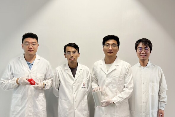 Prof. Yang Zhengbao (second left), Associate Professor at HKUST’s Department of Mechanical and Aerospace Engineering, with the three co-first authors of the study: HKUST postdoctoral fellow Dr. Li Xuemu (second right, holding a roll of printed glycine films), CityU PhD graduate Dr. Zhang Zhuomin (first right), and CityU PhD Student Zheng Yi (first left, with a glycine patch in his hands).