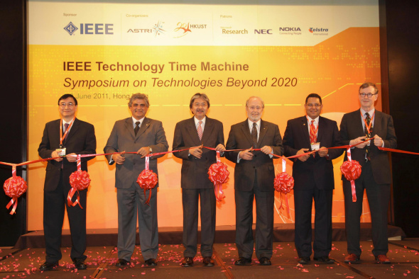 Ribbon cutting by the officiating party. (From left) Dr Cheung Nim-kwan, General Co-Chair of the Organizing Committee; Prof. Roberto de Marca, Executive Chairman of the Organizing Committee; Mr John Tsang, Financial Secretary, Hong Kong SAR Government; Dr Gordon Day, President-Elect, IEEE; Prof. K. B. Letaief, General Co-Chair of the Organizing Committee and HKUST Dean of Engineering; and Prof. Yrjö Neuvo, Program Committee Chair.