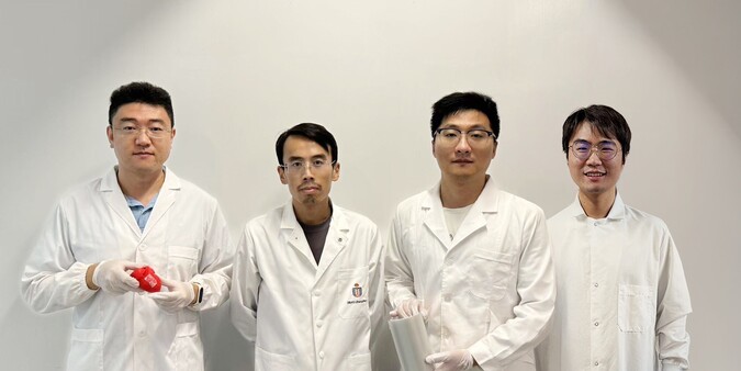 Prof. Yang Zhengbao (second left), Associate Professor at HKUST’s Department of Mechanical and Aerospace Engineering, with the three co-first authors of the study: HKUST postdoctoral fellow Dr. Li Xuemu (second right, holding a roll of printed glycine films), CityU PhD graduate Dr. Zhang Zhuomin (first right), and CityU PhD Student Zheng Yi (first left, with a glycine patch in his hands).