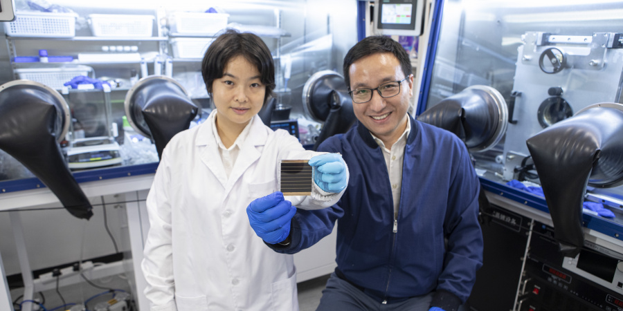 Prof. Zhou Yuanyuan (right) and Dr. Duan Tianwei (left) holding their newly developed perovskite solar cell.