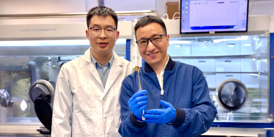 The lead corresponding author Prof. Zhou Yuanyuan (right) and co-first author Dr. Guo Pengfei (left) are showing a perovskite solar cell prototype made for a proof-of-concept demonstration of the novel laminate-structured interface.