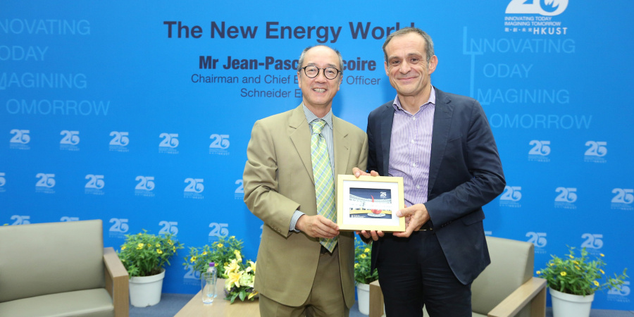 President Tony Chan (left) presents a souvenir to Mr Tricoire.