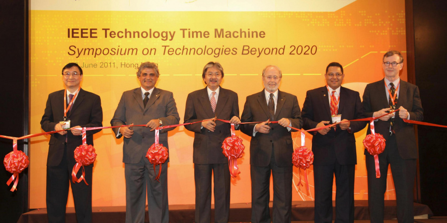 Ribbon cutting by the officiating party. (From left) Dr Cheung Nim-kwan, General Co-Chair of the Organizing Committee; Prof. Roberto de Marca, Executive Chairman of the Organizing Committee; Mr John Tsang, Financial Secretary, Hong Kong SAR Government; Dr Gordon Day, President-Elect, IEEE; Prof. K. B. Letaief, General Co-Chair of the Organizing Committee and HKUST Dean of Engineering; and Prof. Yrjö Neuvo, Program Committee Chair.