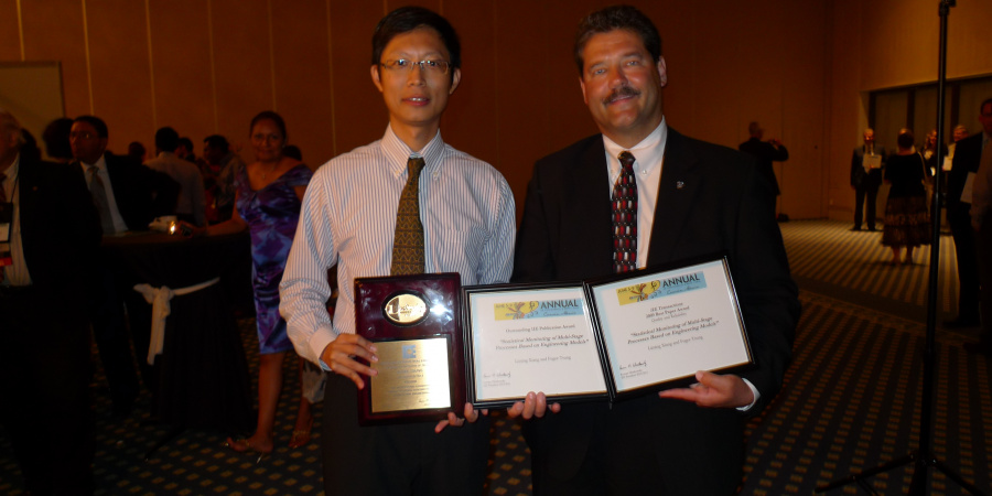 Prof Fugee Tsung (left) with the certificates of the three prestigious awards and Dr Lincoln Forbes, President of IIE, at the Industrial Engineering Research Conference in Cancun, Mexico