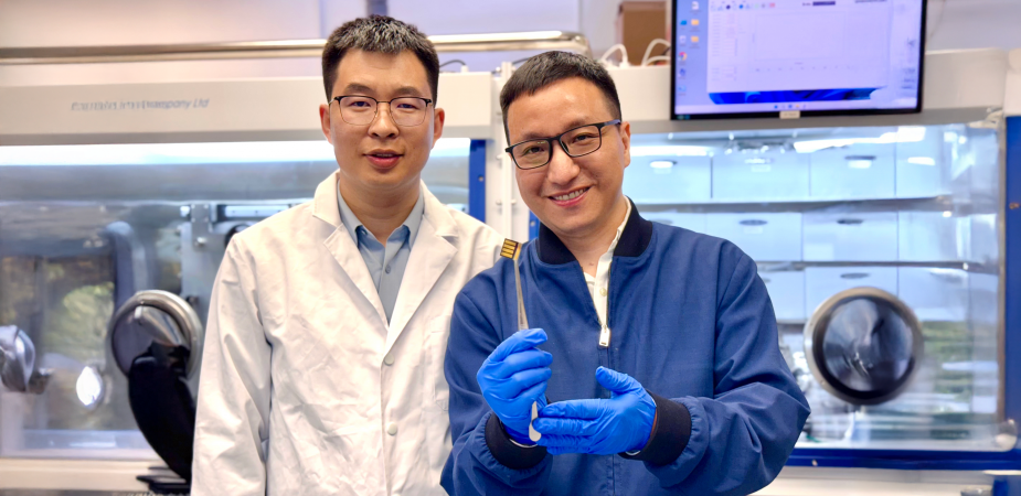 The lead corresponding author Prof. Zhou Yuanyuan (right) and co-first author Dr. Guo Pengfei (left) are showing a perovskite solar cell prototype made for a proof-of-concept demonstration of the novel laminate-structured interface.