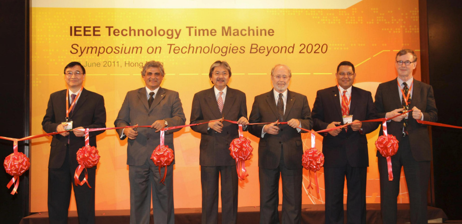 Ribbon cutting by the officiating party. (From left) Dr Cheung Nim-kwan, General Co-Chair of the Organizing Committee; Prof. Roberto de Marca, Executive Chairman of the Organizing Committee; Mr John Tsang, Financial Secretary, Hong Kong SAR Government; Dr Gordon Day, President-Elect, IEEE; Prof. K. B. Letaief, General Co-Chair of the Organizing Committee and HKUST Dean of Engineering; and Prof. Yrjö Neuvo, Program Committee Chair.