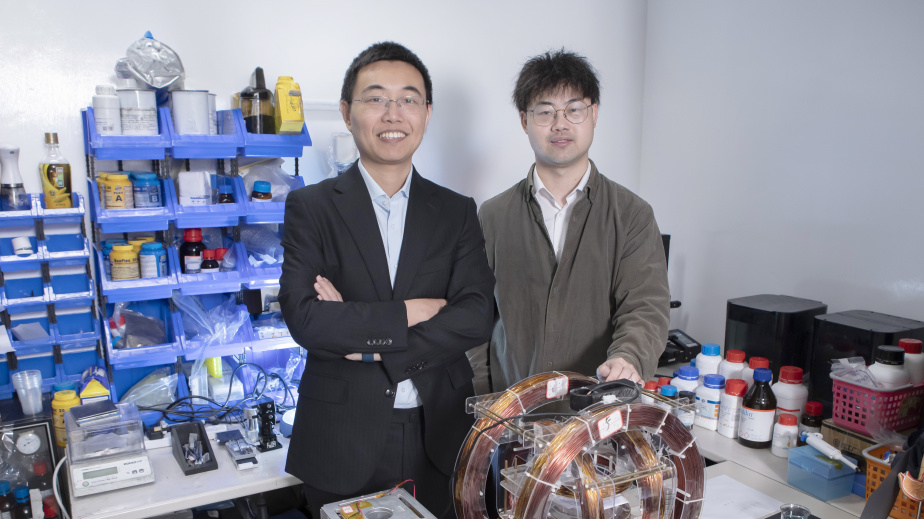 Prof. Shen Yajing (left) and co-first author Dr. Yang Xiong (right) with the magnetic actuation platform for microswimmer control in front.