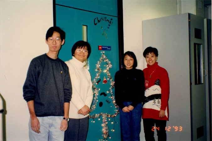 Prof. Ip (first right) celebrates first Christmas at HKUST in 1993 in front of her laboratory with her research team members, some of whom are still her aide to date.