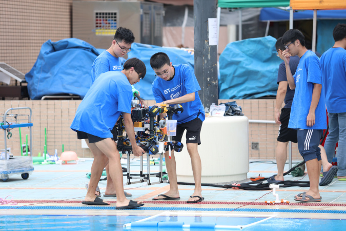 Members of the ROV sub-team move their robot to get ready for the mission.