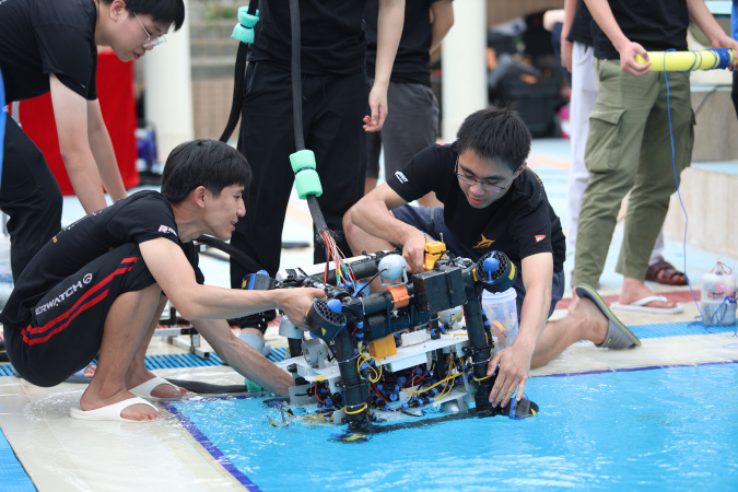 Team members put the robot in water to adjust the buoyancy.