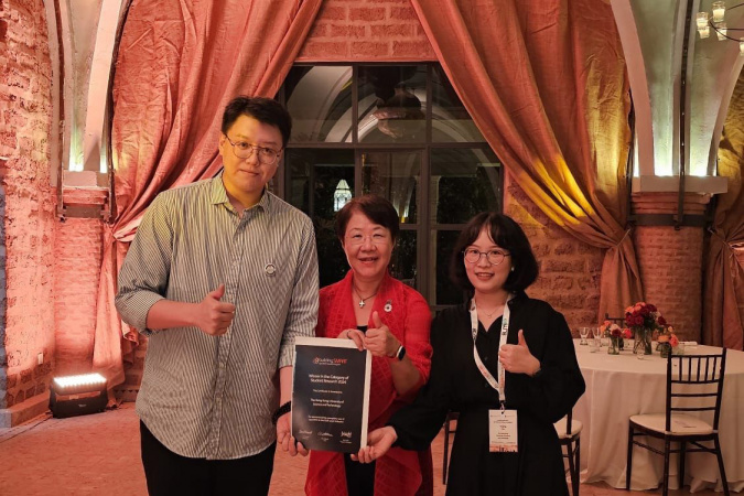 Civil Engineering PhD students Gong Xingbo (left) and Xu Yuqing (right), as well as Prof. Ada Fung (center), Chairperson of the Hong Kong Chapter of buildingSMART International 