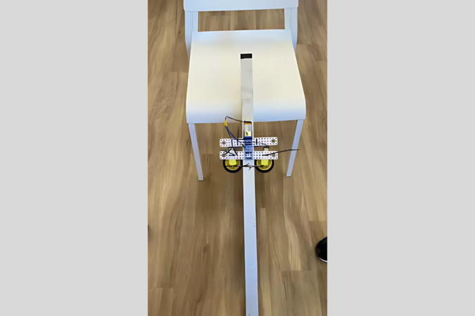 The robot assembled by participants was climbing up the aluminum pole.