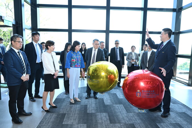 科大郑家纯机器人研究院院长张福民教授（右一），向嘉宾示范这款可近距离安全接近公众的微型自主飞艇。