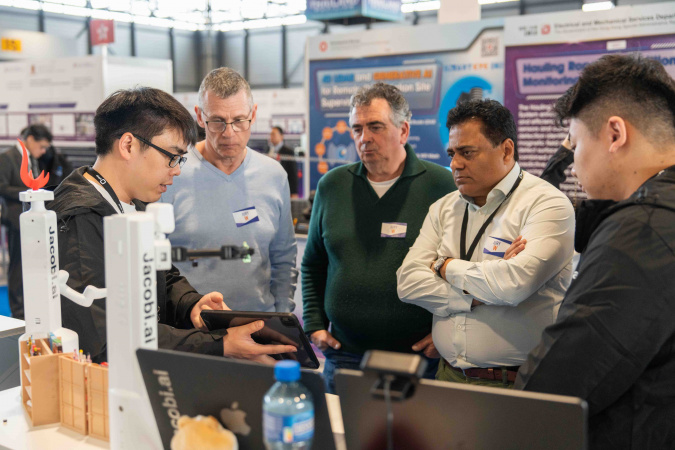 Nearly 40% of HKUST’s submissions this year have deployed AI into their inventions. One of the teams introduces their AI applications in a robotic project to the judges.