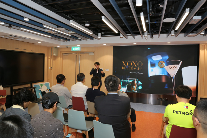 Alumnus Ricky Chan, co-founder of XOXO Beverages, introduced their cocktail mixing machine using innovative fluid mixing and dilution control technology.