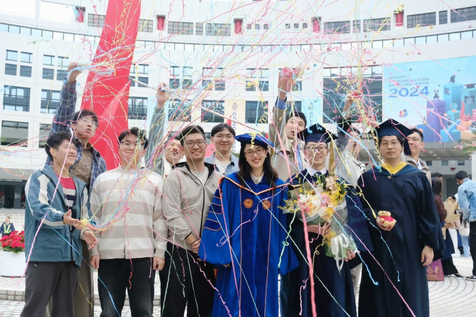 Prof. Wang Yiwen celebrated with her graduating students at the University’s Congregation 2024.