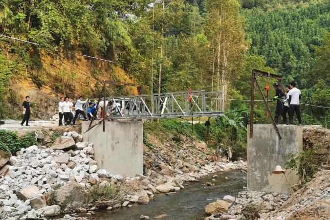 Student volunteers pushed the bridge structure with the assistance of machinery.
