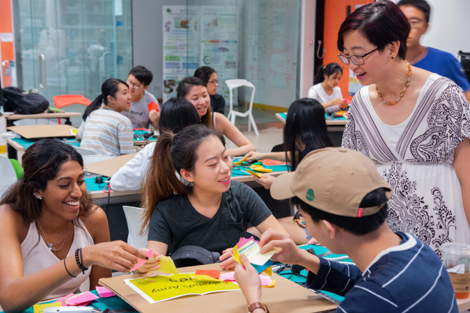 Students go through their post-it ideas with Prof. Chau before a prototyping session at the SIGHT camp.
