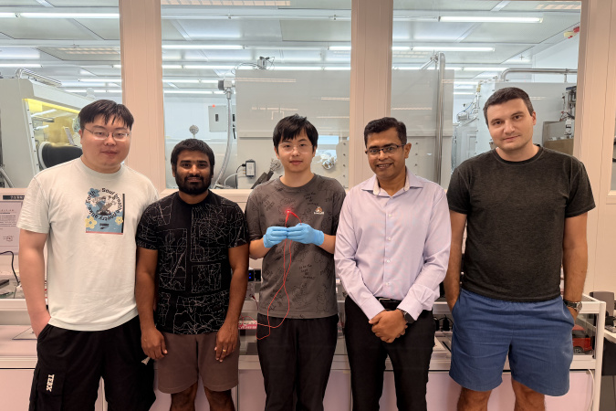 Group photo of the research team: Prof. Abhishek K. Srivastava (second right), corresponding author of the study; Liao Zebing (center), PhD student and first author of the study; as well as co-authors including postdoctoral fellow Dr. Maksym Prodanov (first right), PhD students Mallem Kumar (second left) and Song Jianxin (first left). Mr Liao holds a red emitting QR-LED sample.