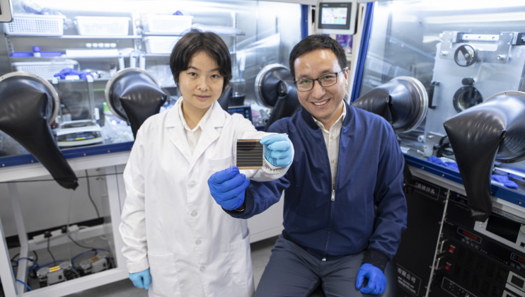 Prof. Zhou Yuanyuan (right) and Dr. Duan Tianwei (left) holding their newly developed perovskite solar cell.