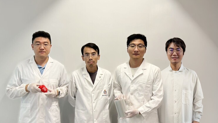 Prof. Yang Zhengbao (second left), Associate Professor at HKUST’s Department of Mechanical and Aerospace Engineering, with the three co-first authors of the study: HKUST postdoctoral fellow Dr. Li Xuemu (second right, holding a roll of printed glycine films), CityU PhD graduate Dr. Zhang Zhuomin (first right), and CityU PhD Student Zheng Yi (first left, with a glycine patch in his hands).