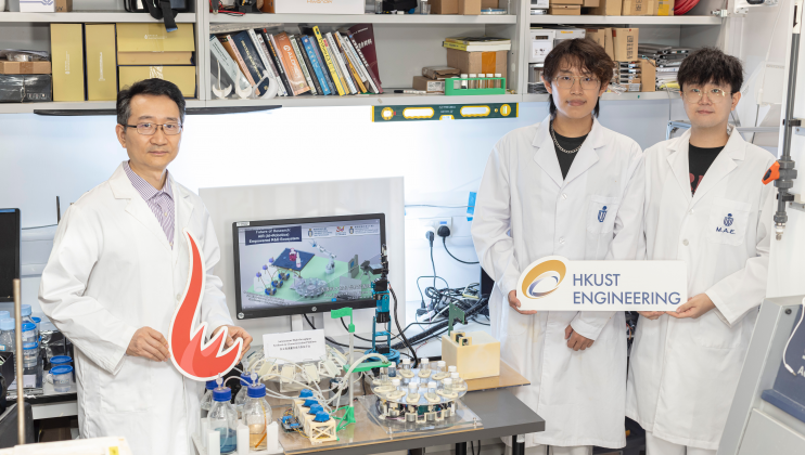 香港科技大學機械及航空航天工程學系研究團隊研發的自主高通量合成與表徵平台（置於桌上）。團隊成員包括楊晶磊教授（左一）、博士生馬國雄（右一）及哲學碩士畢業生崔昊哲（右二）。